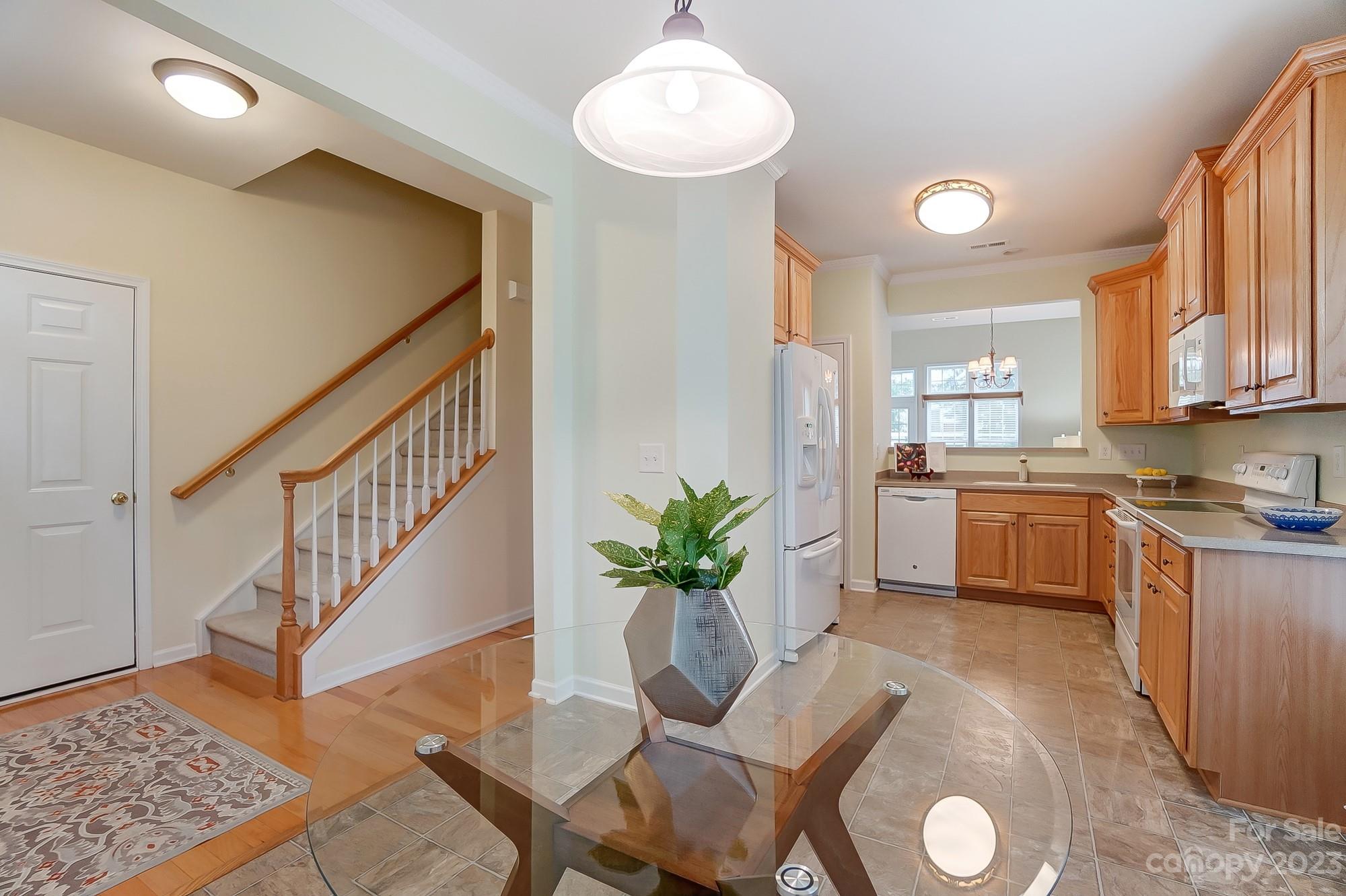 179 Snead Road Fort Mill, SC 29715 - Photo 25 of 48 a living room with kitchen island furniture and a chandelier