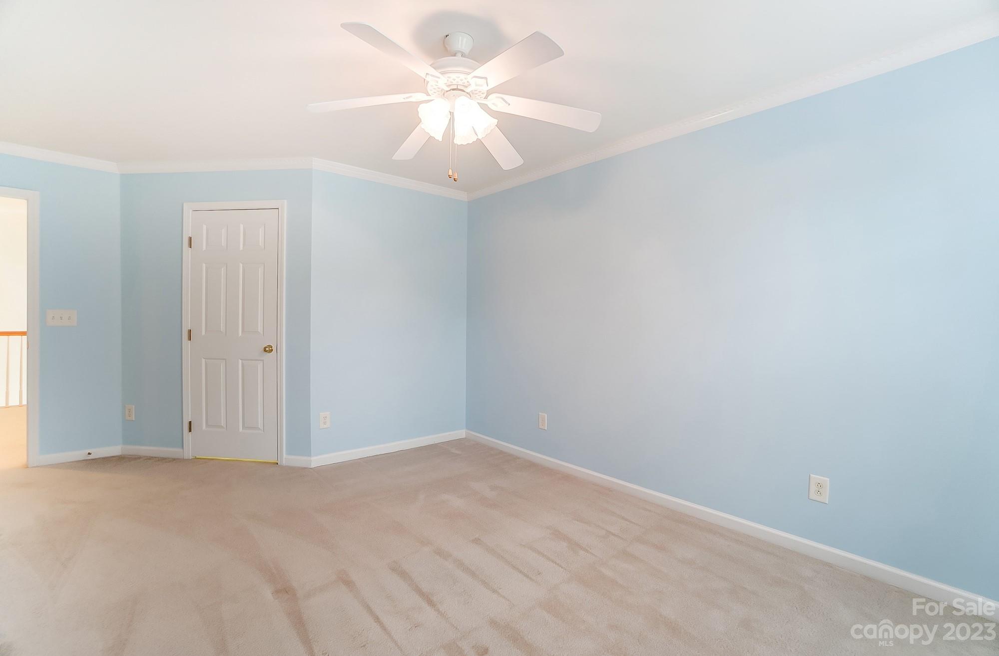 179 Snead Road Fort Mill, SC 29715 - Photo 35 of 48 an empty room with a chandelier fan and windows