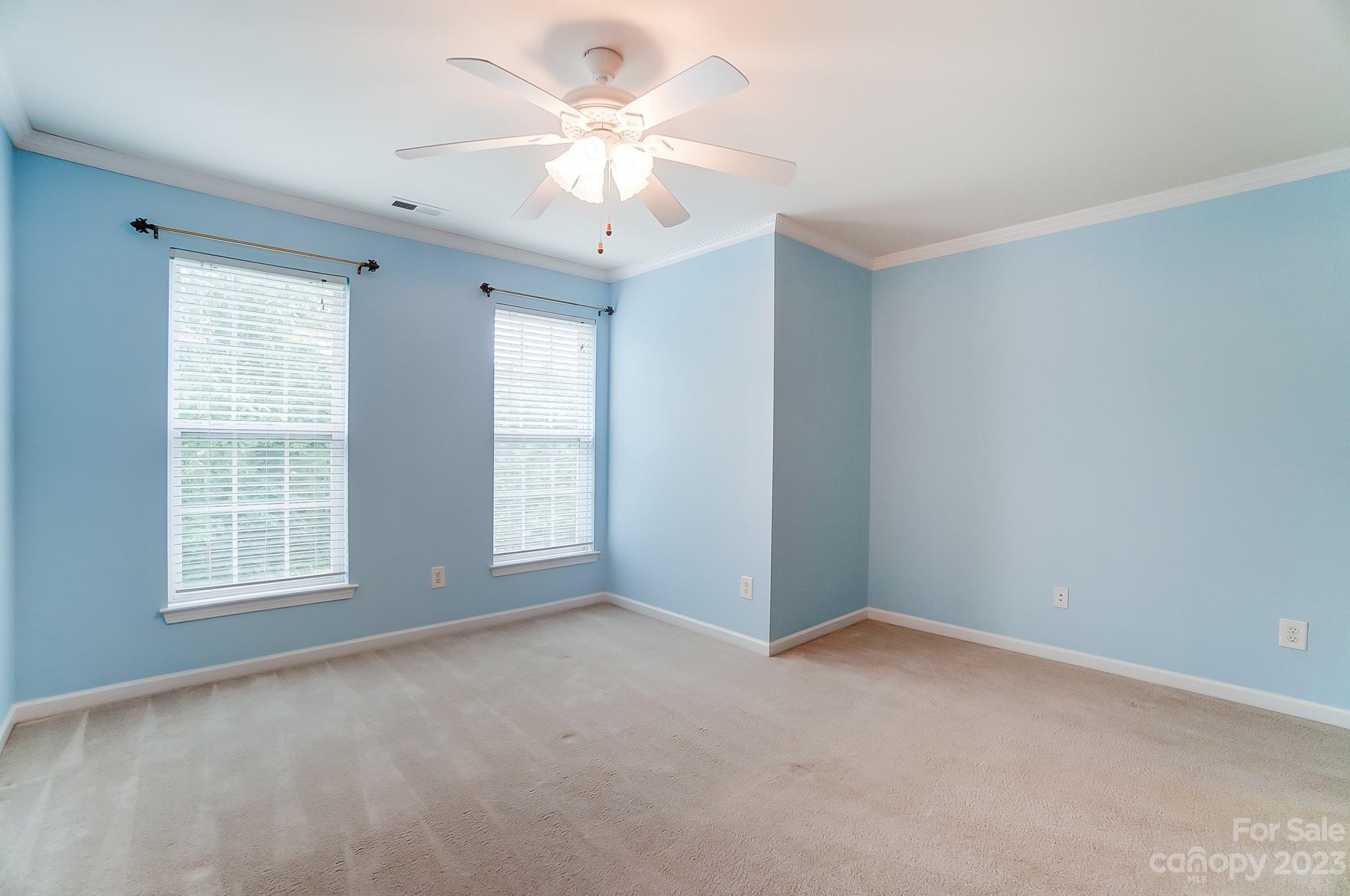 179 Snead Road Fort Mill, SC 29715 - Photo 36 of 48 an empty room with chandelier fan and windows