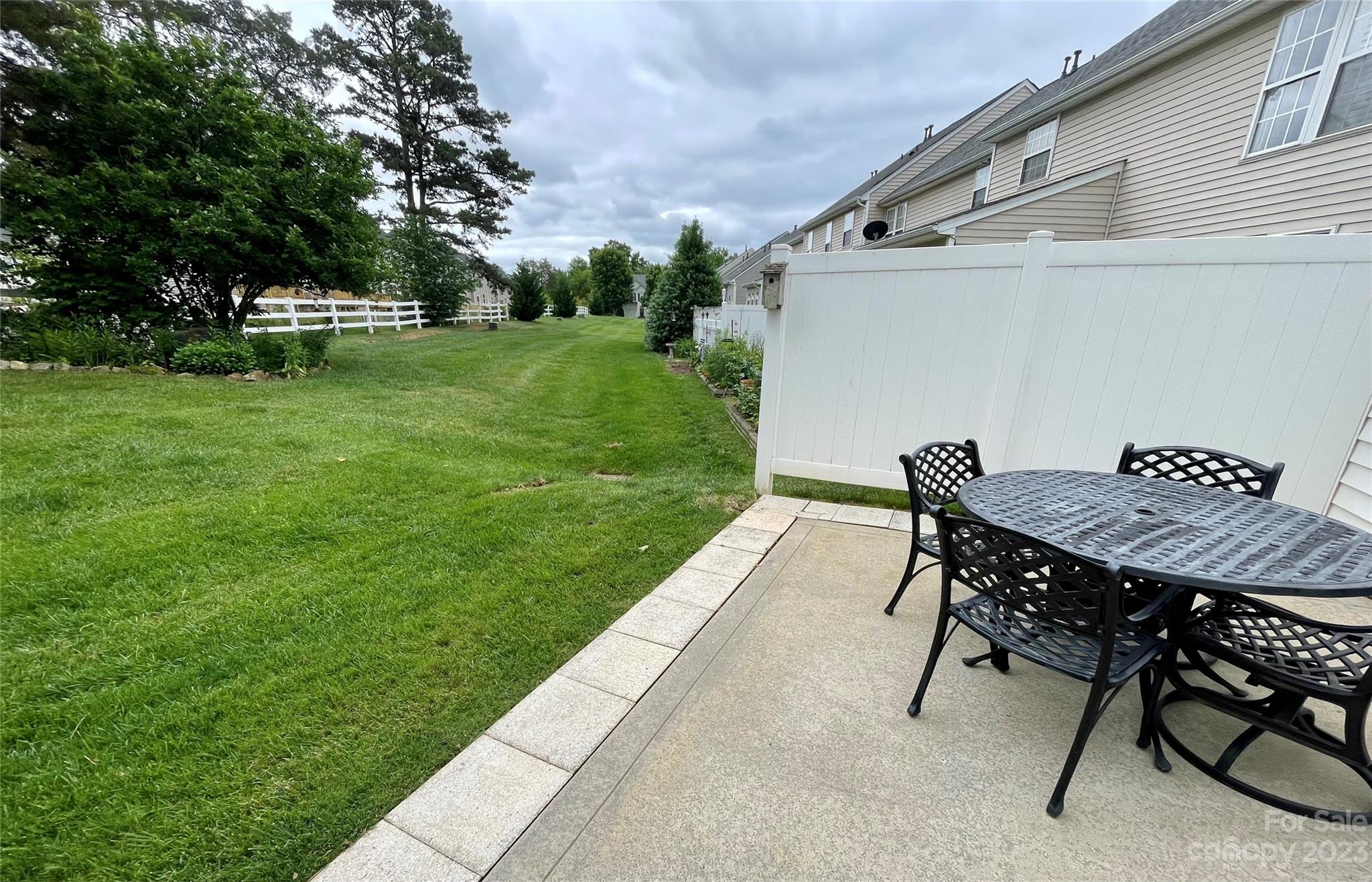 179 Snead Road Fort Mill, SC 29715 - Photo 45 of 48 a view of a patio with table and chairs and garden