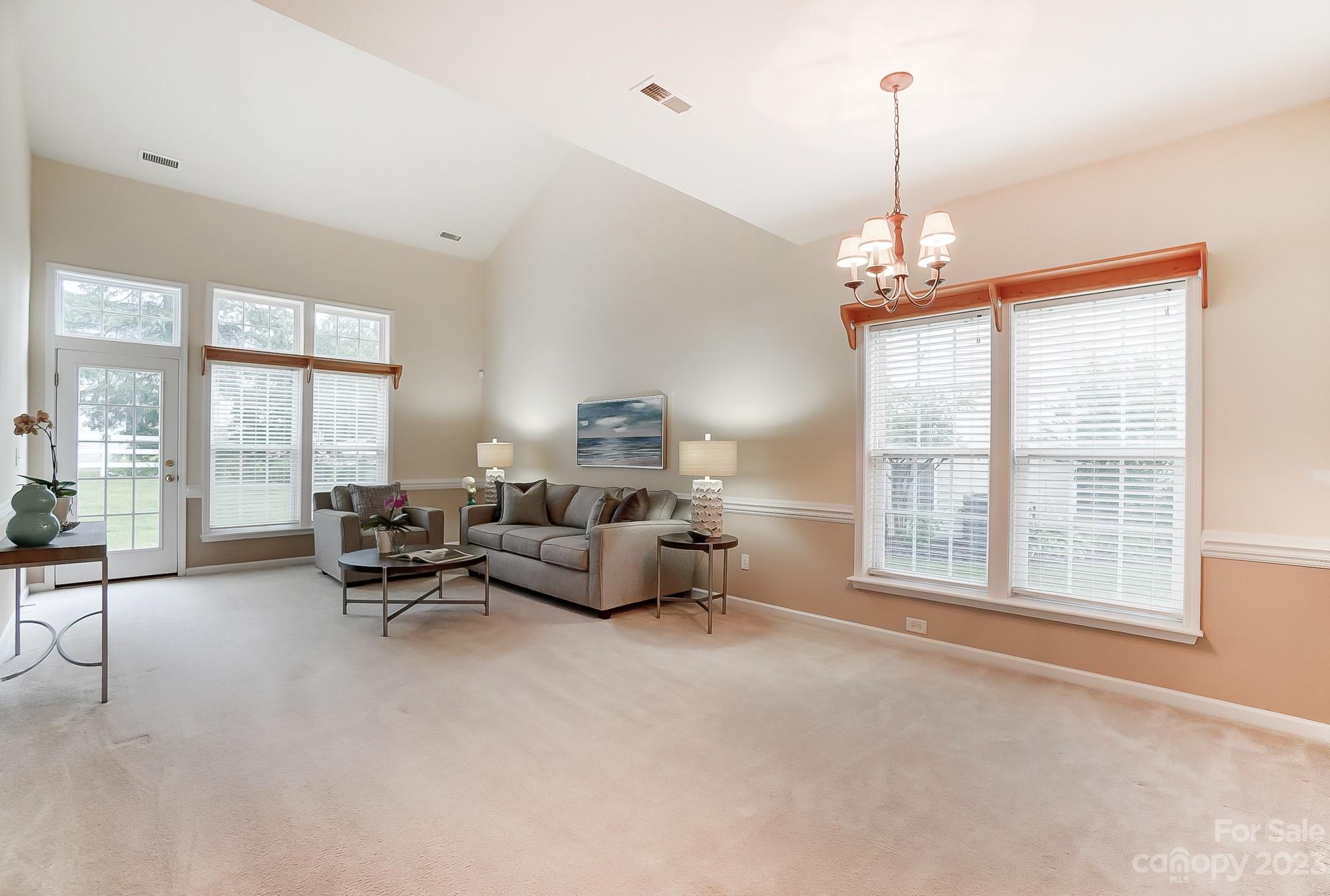 179 Snead Road Fort Mill, SC 29715 - Photo 9 of 48 a living room with furniture and a chandelier