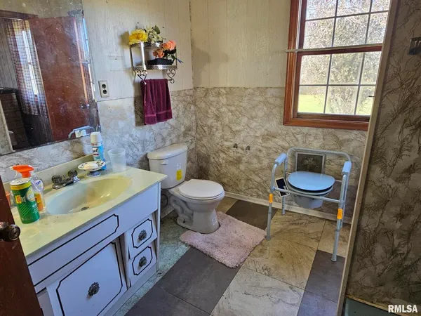 a bathroom with a sink toilet and mirror