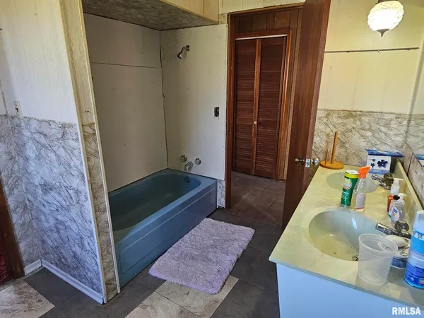 a bathroom with a sink a bathtub and a shower