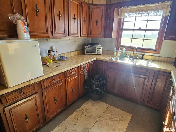 a kitchen with granite countertop wooden cabinets a sink and dishwasher