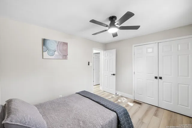 a bedroom with a large bed and a chandelier