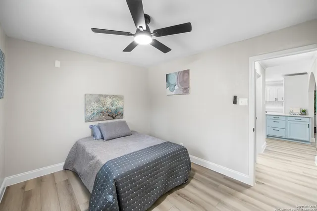 a bedroom with a large bed and a chandelier
