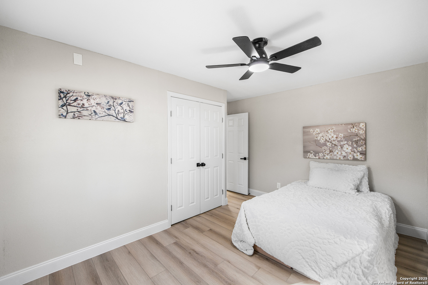 1230 Echo Meadow Lane Spring Branch, TX 78070 - Photo 15 of 31 a bedroom with a large bed and a ceiling fan
