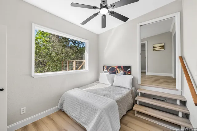 a bedroom with a bed and a window