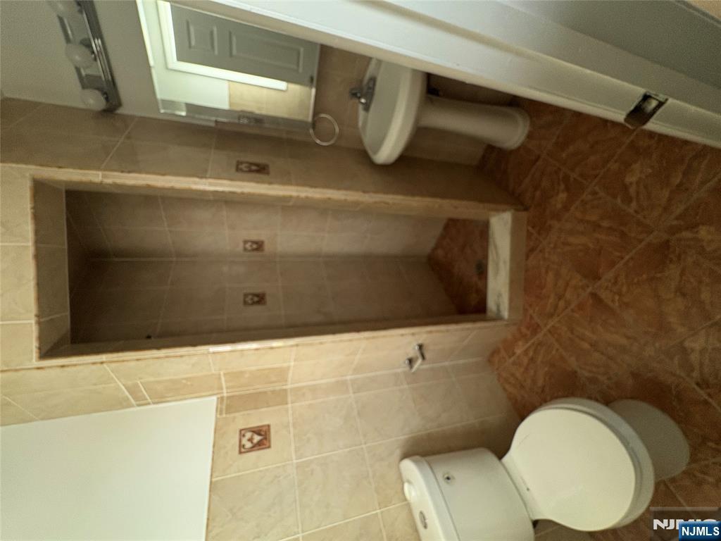 70 Pink Street, Unit 2 Hackensack, NJ 07601 - Photo 12 of 13 a bathroom with a toilet and a shower