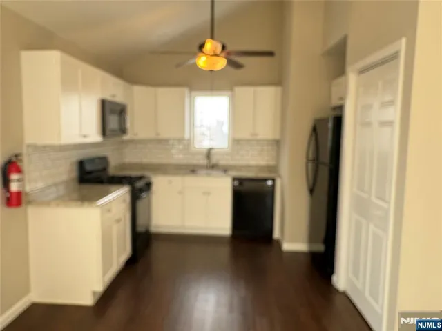 a kitchen with a refrigerator and a sink