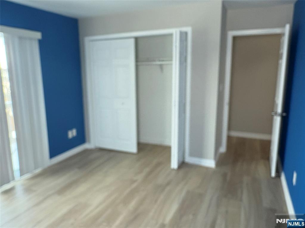 70 Pink Street, Unit 2 Hackensack, NJ 07601 - Photo 8 of 13 an empty room with wooden floor and closet