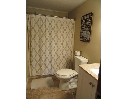 113 Draper Road East Brookfield, MA 01515 - Photo 15 of 33 a white toilet sitting next to a shower curtain