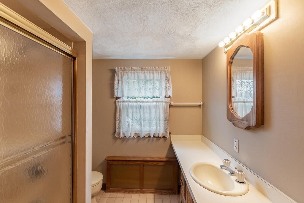1 King Street Wakefield, MA 01880 - Photo 14 of 25 a bathroom with a granite countertop sink toilet and shower