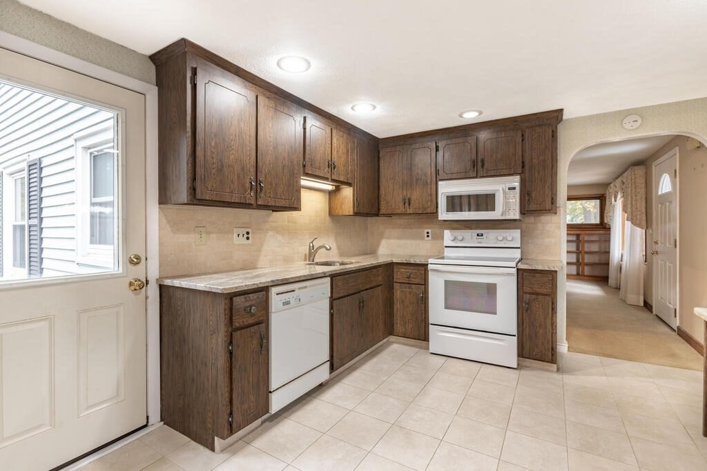 1 King Street Wakefield, MA 01880 - Photo 3 of 25 a kitchen with a stove sink and cabinets
