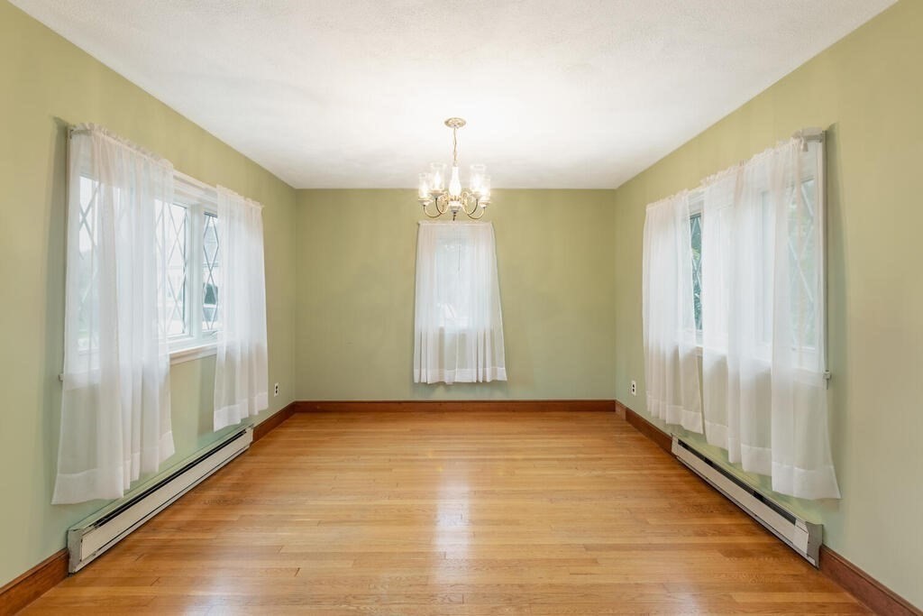 1 King Street Wakefield, MA 01880 - Photo 5 of 25 a view of an empty room with wooden floor and a window