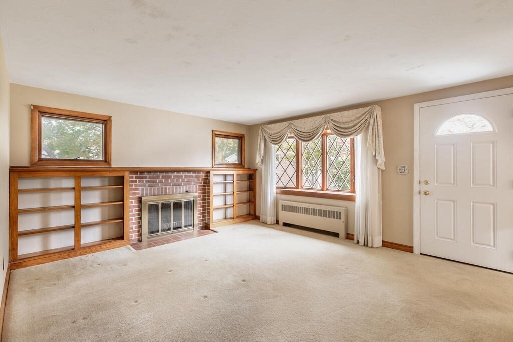 1 King Street Wakefield, MA 01880 - Photo 7 of 25 an empty room with furniture and a fireplace