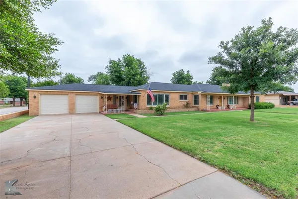 a front view of house with yard and green space