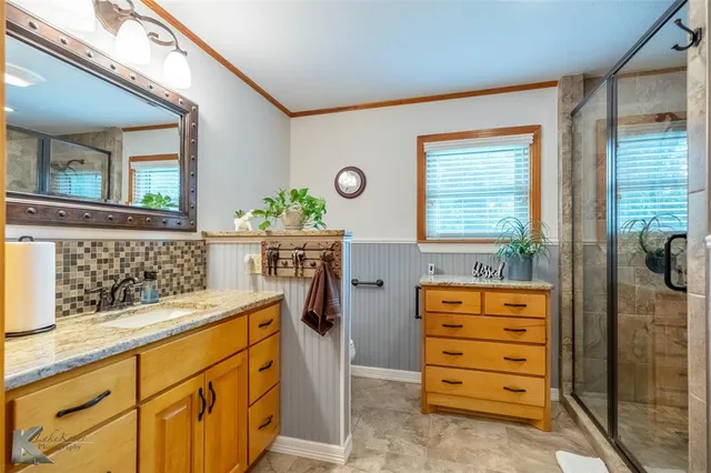 a bathroom with a sink a mirror and a window