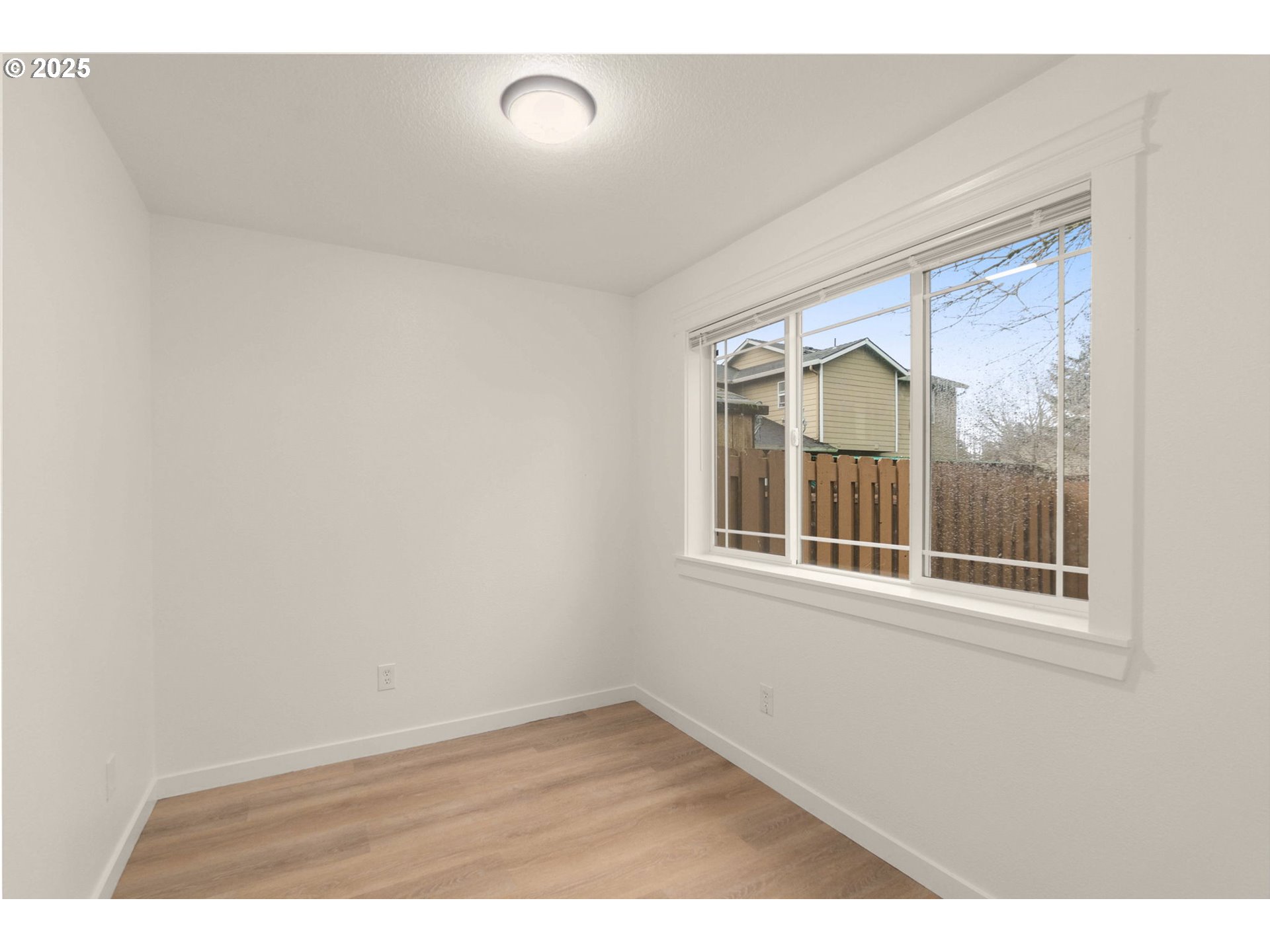 14553 Southeast Rhine Street Portland, OR 97236 - Photo 13 of 26 a view of empty room with windows