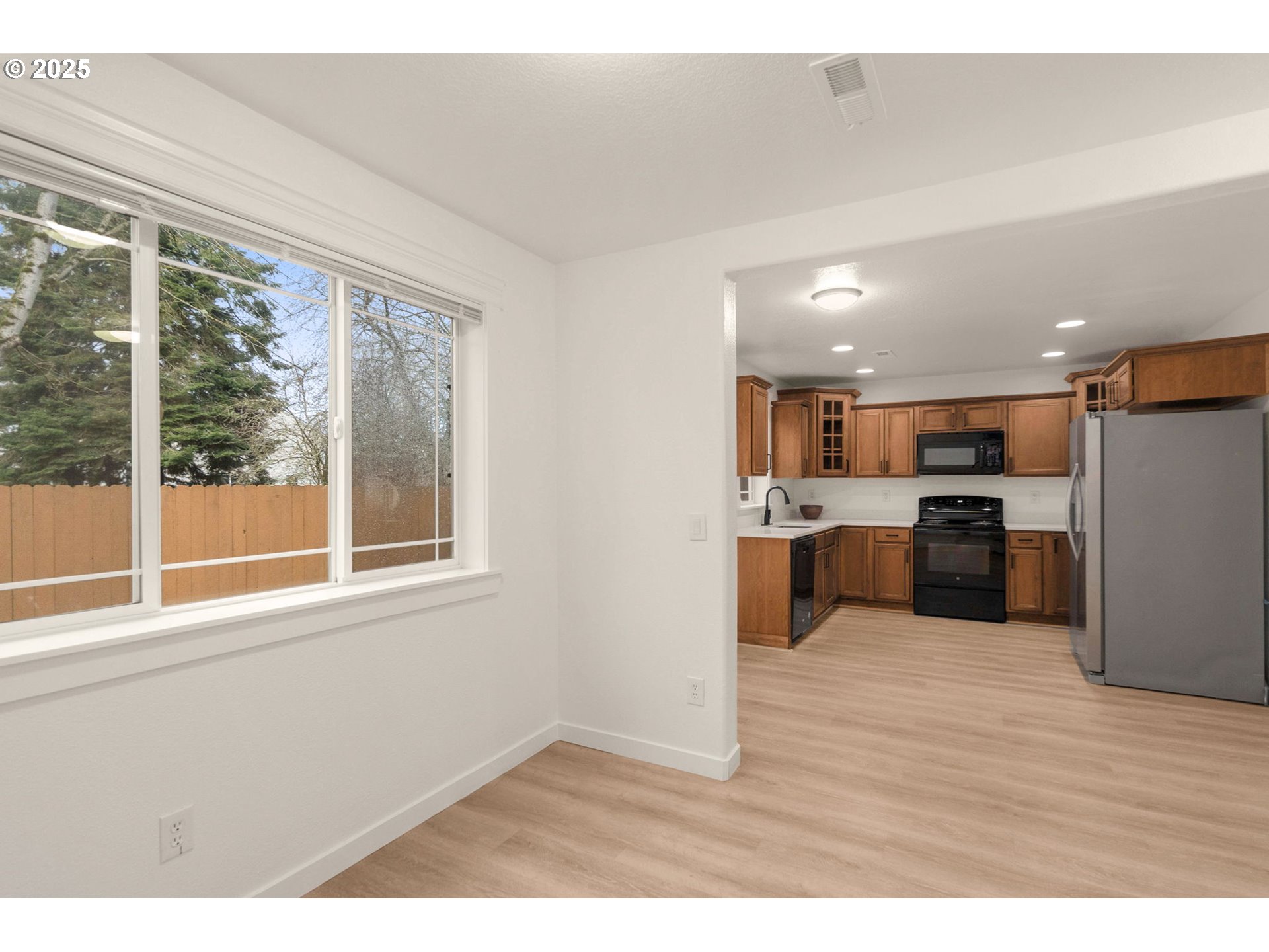 14553 Southeast Rhine Street Portland, OR 97236 - Photo 14 of 26 a view of kitchen with wooden floor