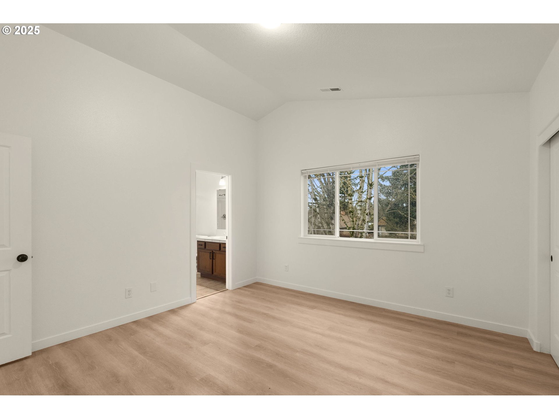 14553 Southeast Rhine Street Portland, OR 97236 - Photo 18 of 26 an empty room with wooden floor and windows