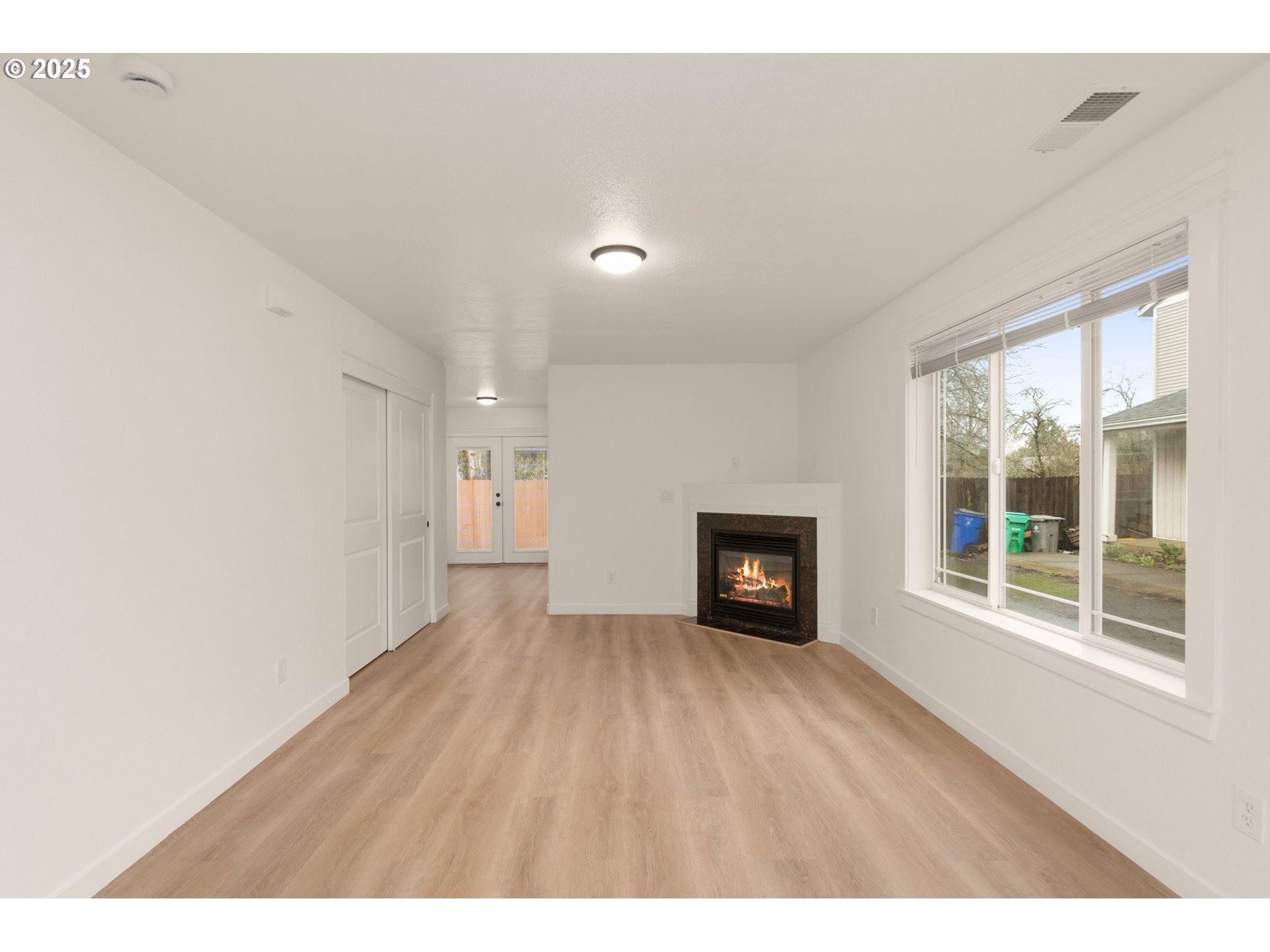14553 Southeast Rhine Street Portland, OR 97236 - Photo 7 of 26 a view of an empty room with a window and fireplace