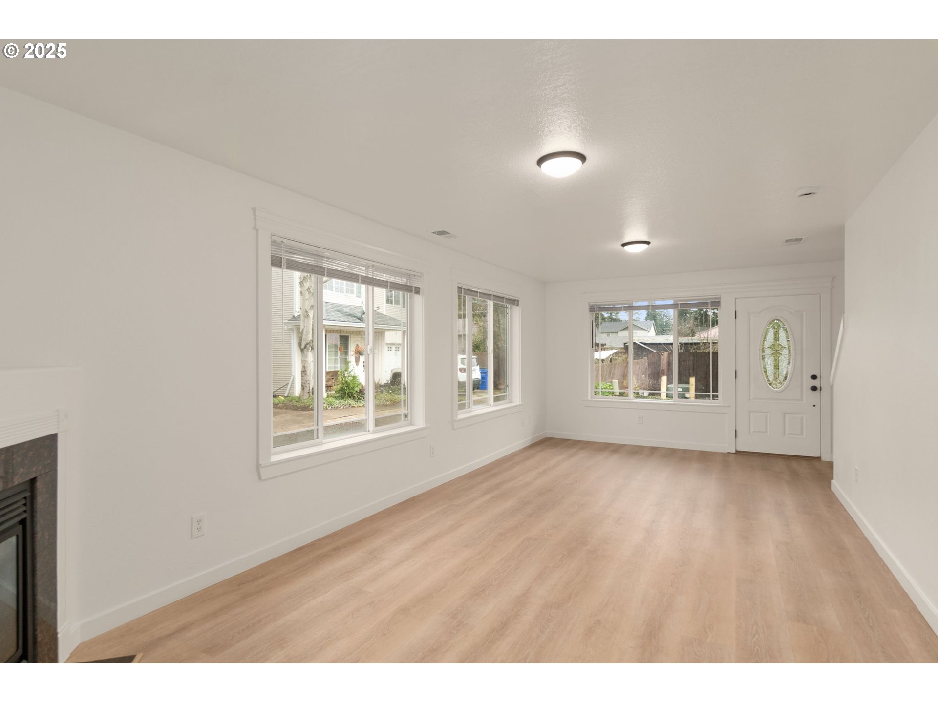 14553 Southeast Rhine Street Portland, OR 97236 - Photo 8 of 26 a view of an empty room with a window and wooden floor