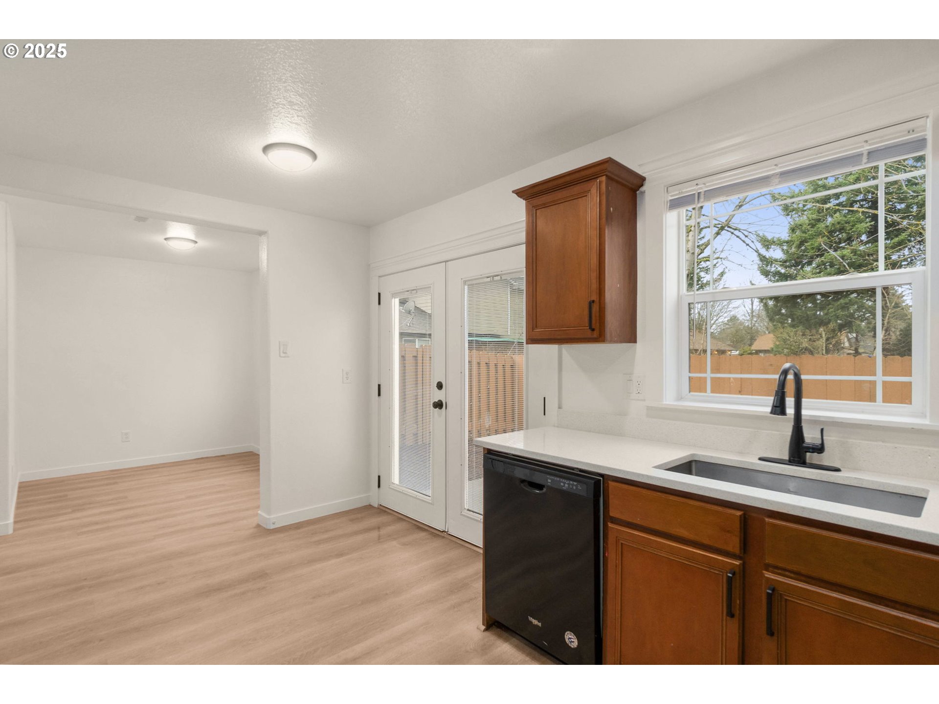 14553 Southeast Rhine Street Portland, OR 97236 - Photo 10 of 26 a kitchen with a sink cabinets and a window