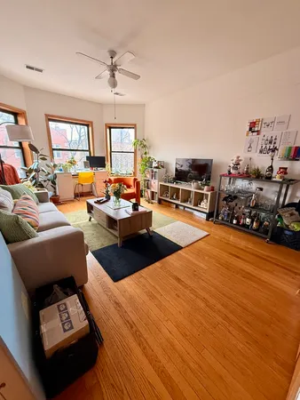 a living room with furniture a fireplace and a large window
