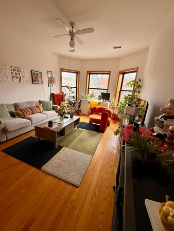 a living room with furniture a window and a flat screen tv