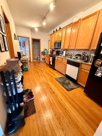 a view of a living room with furniture and kitchen view