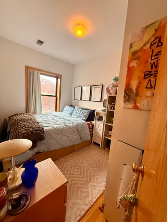 a bedroom with a bed and window