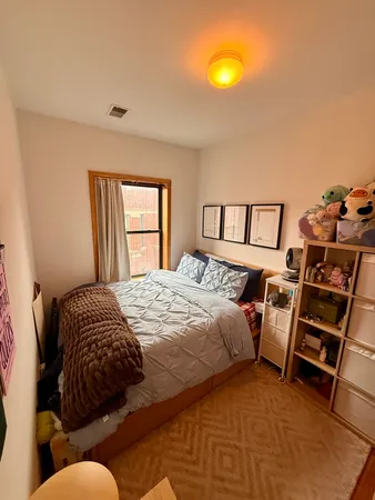 a bedroom with a bed and a window