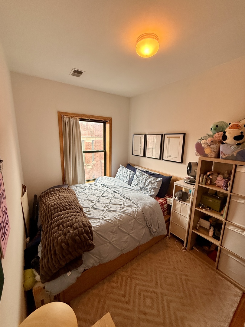 626 West Patterson Avenue, Unit 3W Chicago, IL 60613 - Photo 8 of 11 a bedroom with a bed and a window
