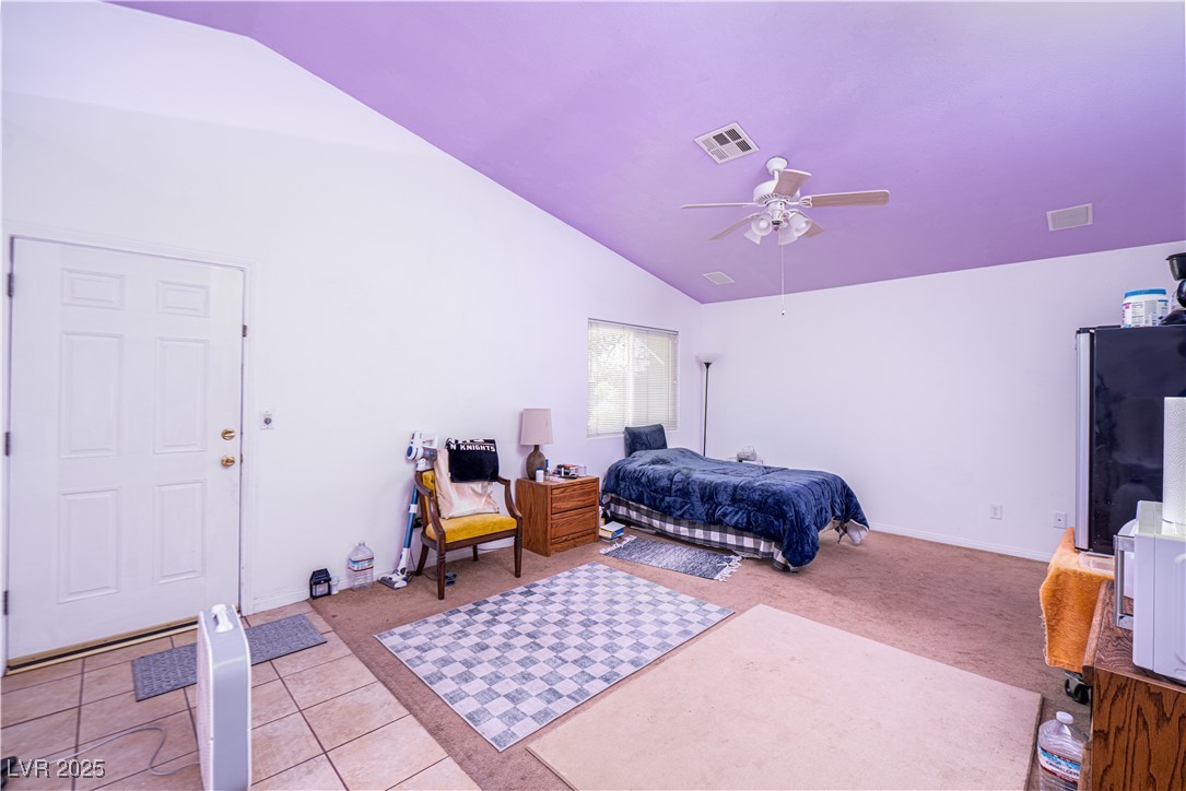 475 East Robindale Road Las Vegas, NV 89123 - Photo 11 of 41 Bedroom with lofted ceiling, light carpet, ceiling fan, baseboards, and light tile patterned floors