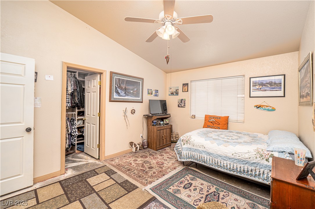 475 East Robindale Road Las Vegas, NV 89123 - Photo 15 of 41 Bedroom featuring lofted ceiling, baseboards, a spacious closet, and a ceiling fan