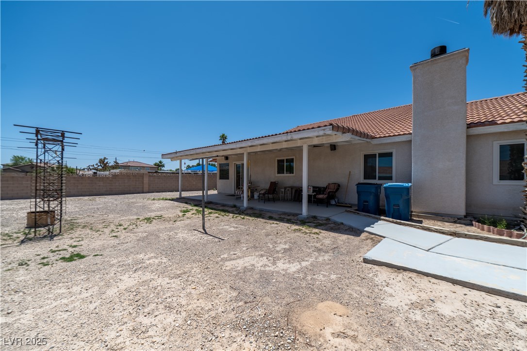 475 East Robindale Road Las Vegas, NV 89123 - Photo 23 of 41 Rear view of property with a tiled roof, a chimney, a patio area, a fenced backyard, and stucco siding