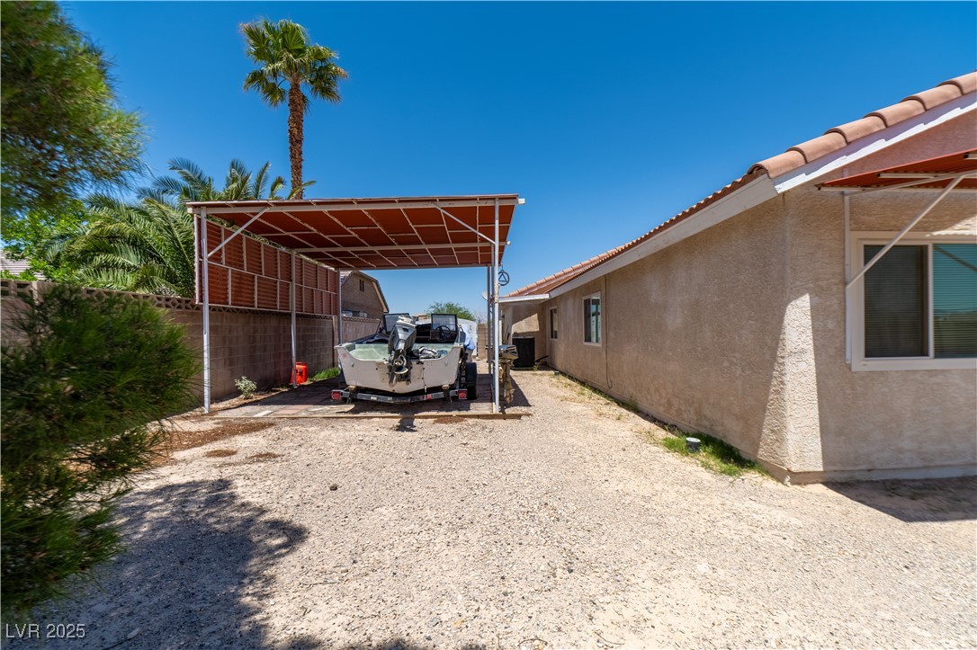 475 East Robindale Road Las Vegas, NV 89123 - Photo 24 of 41 View of parking featuring a detached carport and gravel driveway