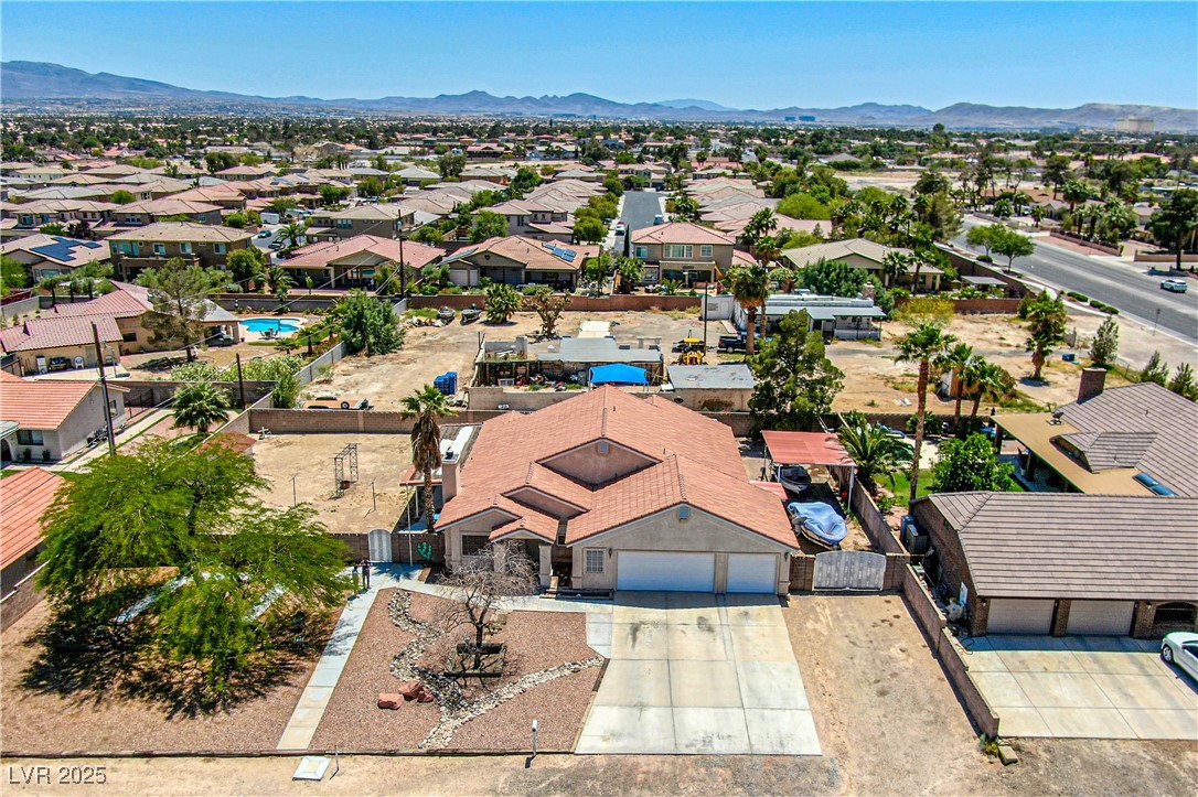 475 East Robindale Road Las Vegas, NV 89123 - Photo 29 of 41 Aerial view of residential area featuring a mountain backdrop