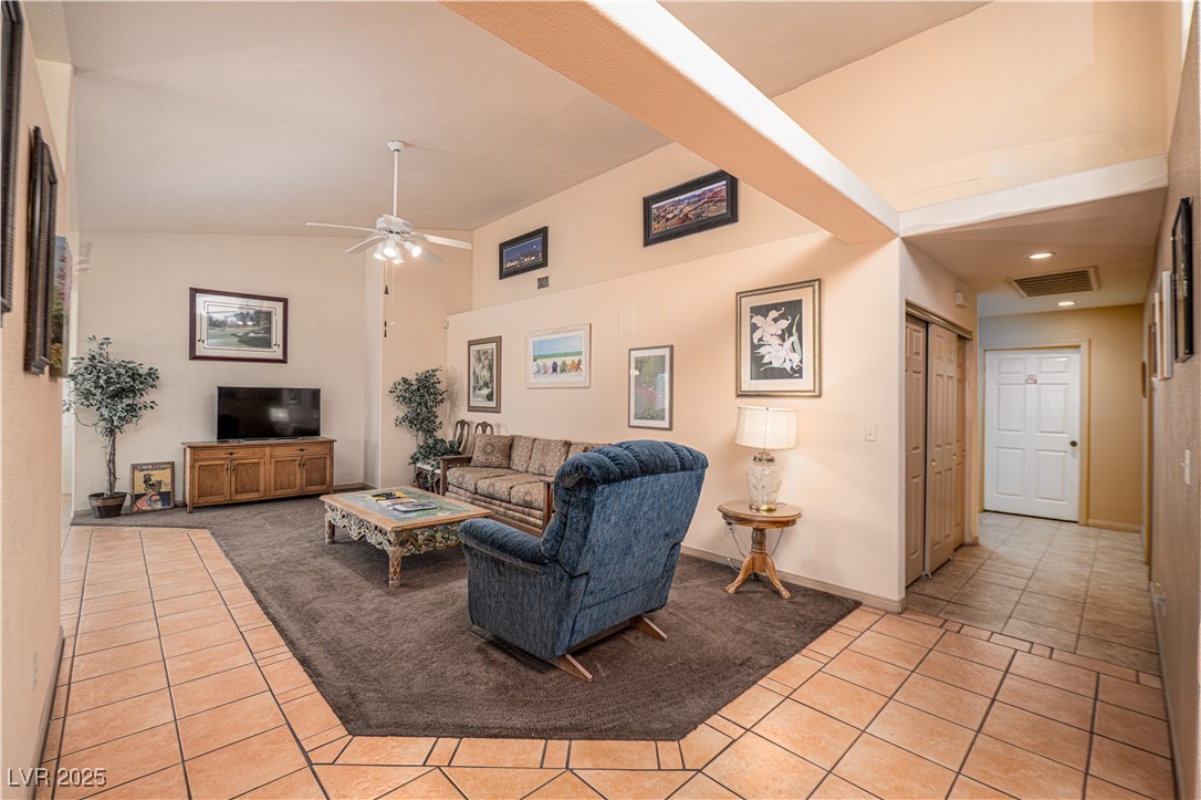 475 East Robindale Road Las Vegas, NV 89123 - Photo 5 of 41 Living room with light tile patterned floors, a ceiling fan, high vaulted ceiling, and baseboards