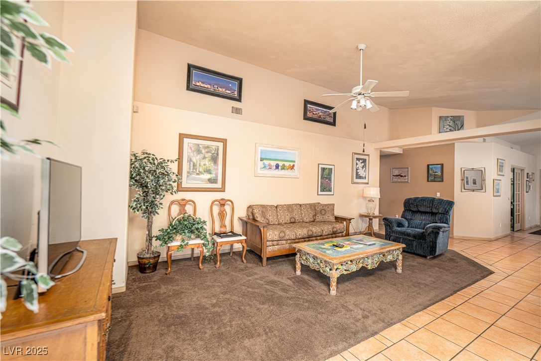 475 East Robindale Road Las Vegas, NV 89123 - Photo 6 of 41 Living area featuring ceiling fan, tile patterned flooring, and lofted ceiling