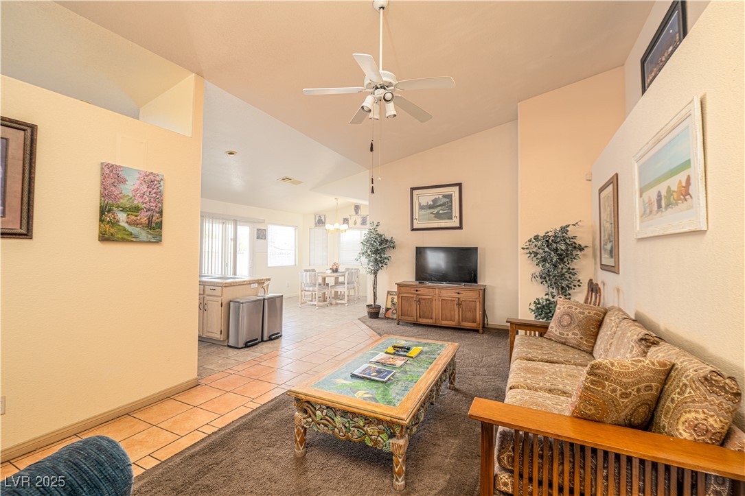 475 East Robindale Road Las Vegas, NV 89123 - Photo 7 of 41 Living area featuring a ceiling fan, light tile patterned flooring, and high vaulted ceiling