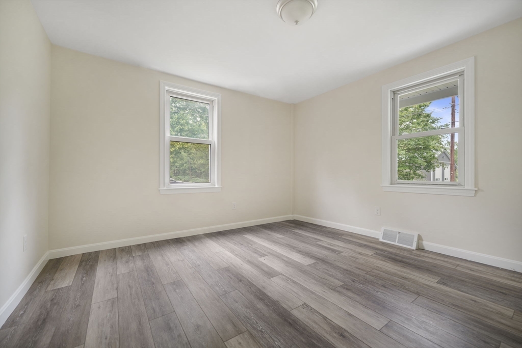 1030 Oak Street Dighton, MA 02764 - Photo 11 of 20 a view of an empty room with wooden floor and a window