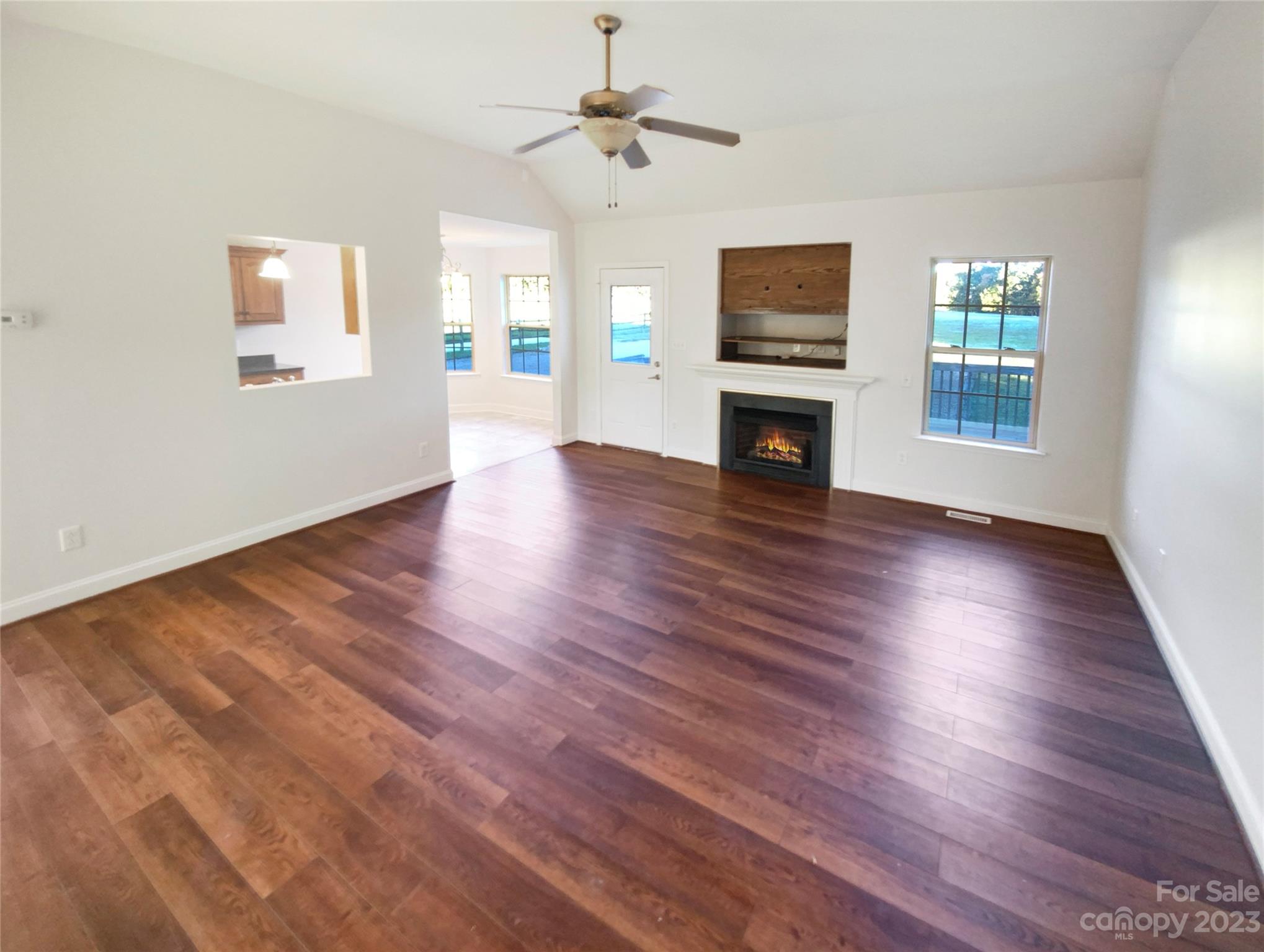 2900 Ruben Road Monroe, NC 28112 - Photo 3 of 21 a view of a livingroom with wooden floor a fireplace and windows
