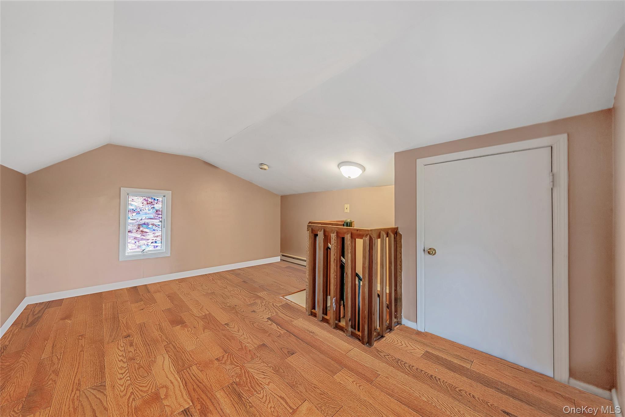 93 Maple Road Kings Park, NY 11754 - Photo 20 of 24 a view of an empty room with wooden floor