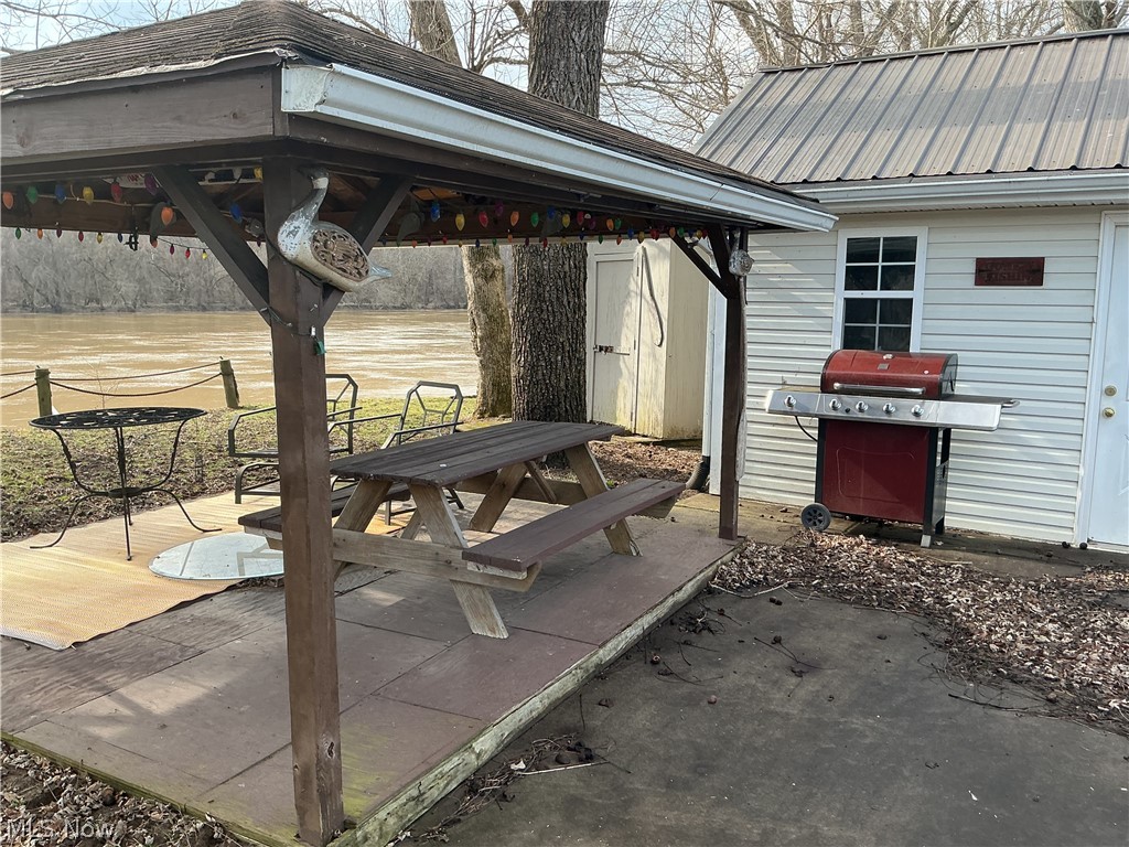 9385 North River Road East, Unit 33 Dresden, OH 43821 - Photo 4 of 19 View of patio featuring a gazebo, a grill, outdoor dining area, and a storage shed
