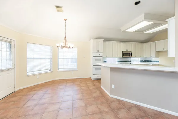 a kitchen with stainless steel appliances a refrigerator sink and cabinets
