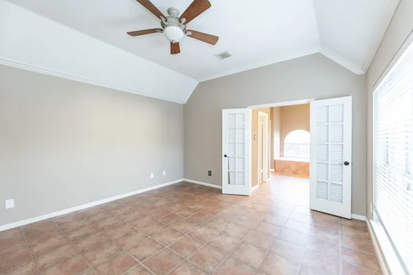 a view of a room with a windows and ceiling fan