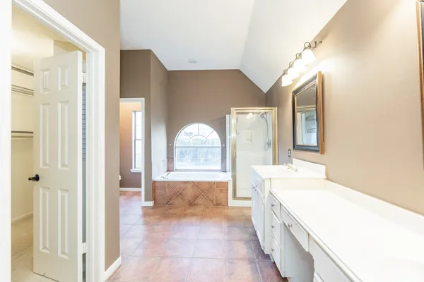 a bathroom with a granite countertop sink a toilet and a shower