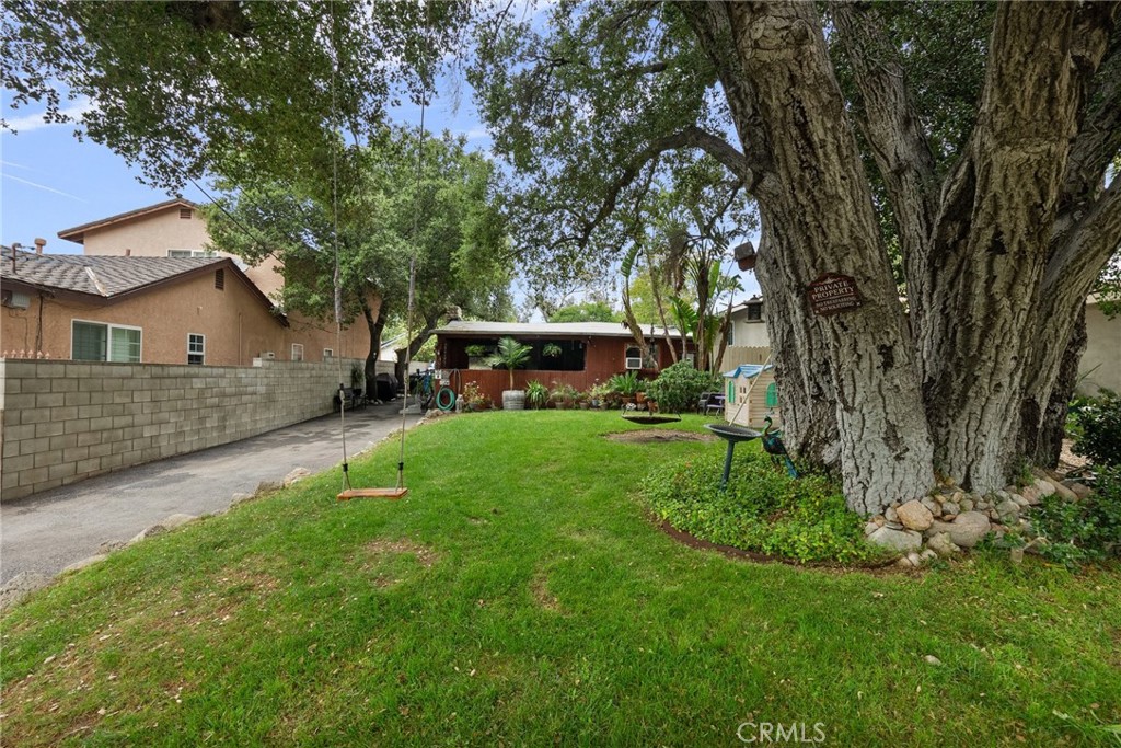 a view of an house with backyard space and sitting area